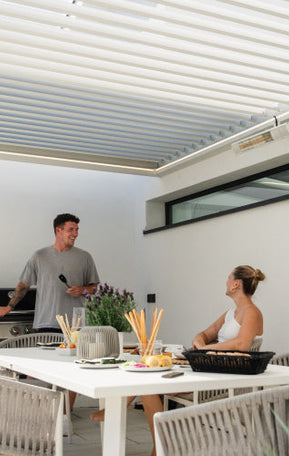 grilling under white pergola
