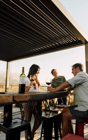 guests under pergola in the sun