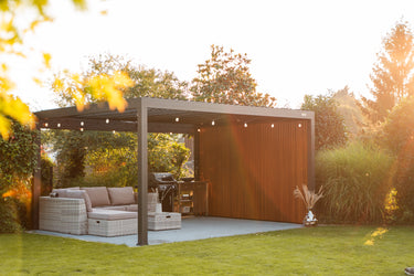 Outdoor patio area with pergola, furniture, and garden setting