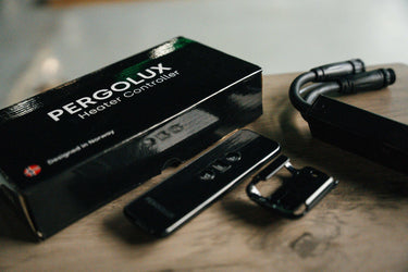 Pergolux heater controller with packaging on a wooden surface