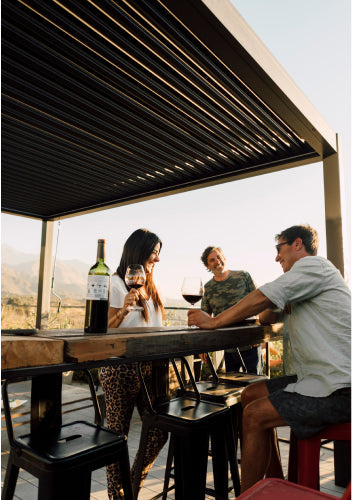 guests under pergola in the sun