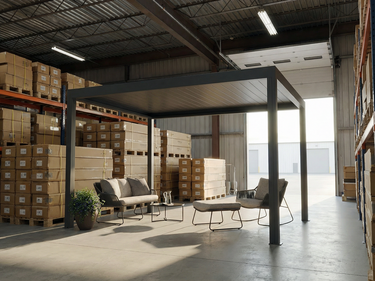 Modern outdoor furniture set under a metal pergola in a warehouse setting with stacked boxes.