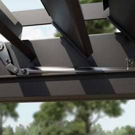 Close-up of a metal pergola motor with blurred greenery in the background